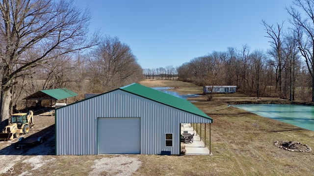 view of outdoor structure featuring driveway and an outbuilding