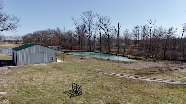 view of yard with an outbuilding and a forest view