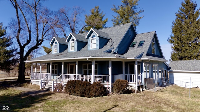 view of front of home with a shingled roof, a front lawn, and a porch