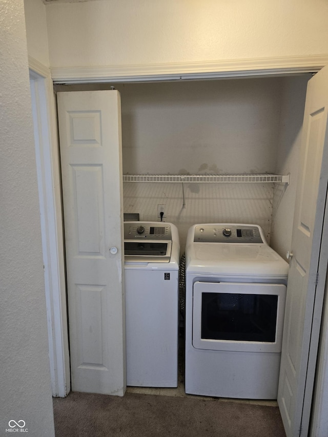 laundry area with carpet flooring and separate washer and dryer