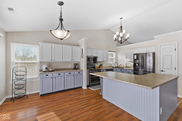 kitchen with sink, hanging light fixtures, dark hardwood / wood-style floors, and stainless steel appliances