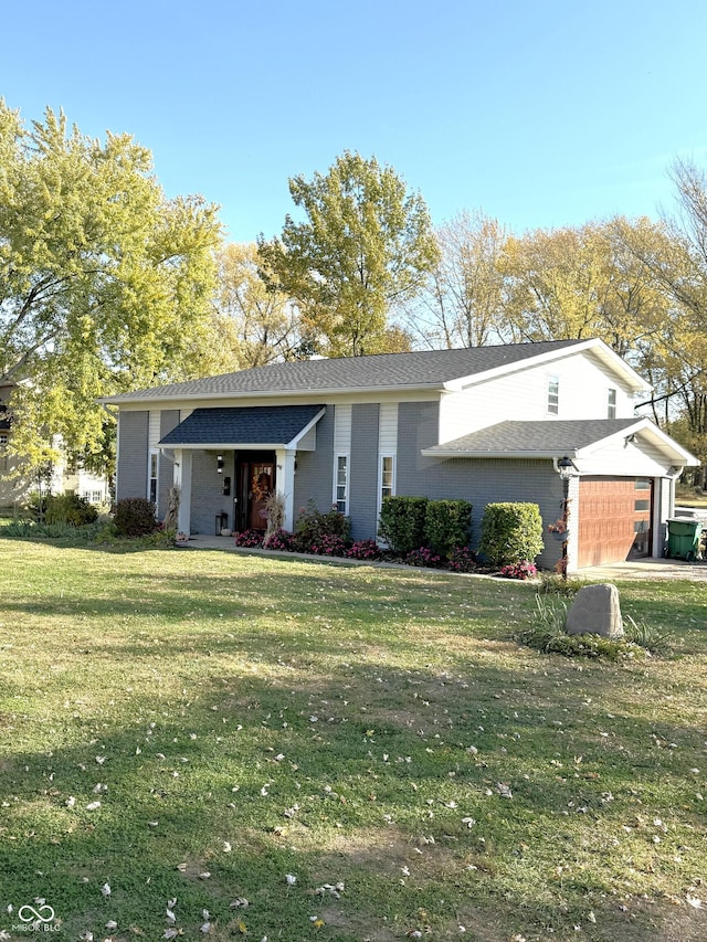 view of front of home featuring a front yard and a garage