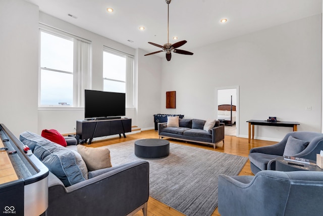 living room with ceiling fan and hardwood / wood-style floors