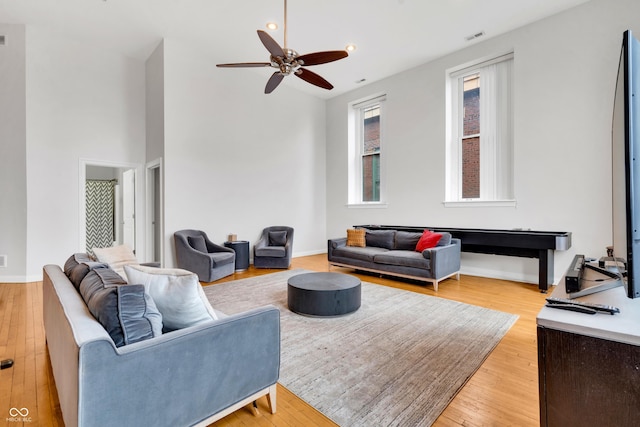 living room featuring light wood-type flooring and ceiling fan