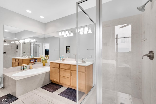 bathroom featuring tile patterned flooring, vanity, and shower with separate bathtub