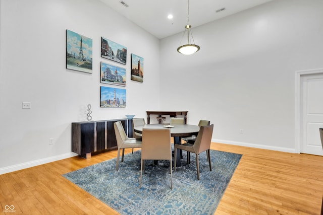 dining space with hardwood / wood-style floors