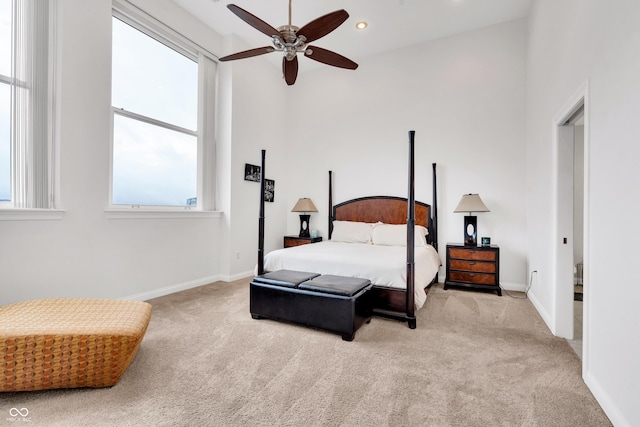 bedroom with light colored carpet and ceiling fan