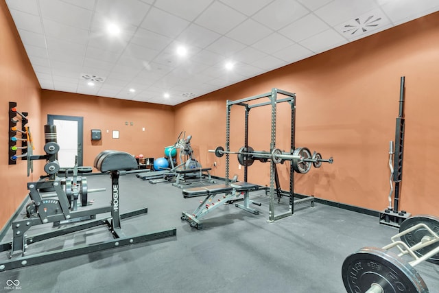 workout area with a paneled ceiling