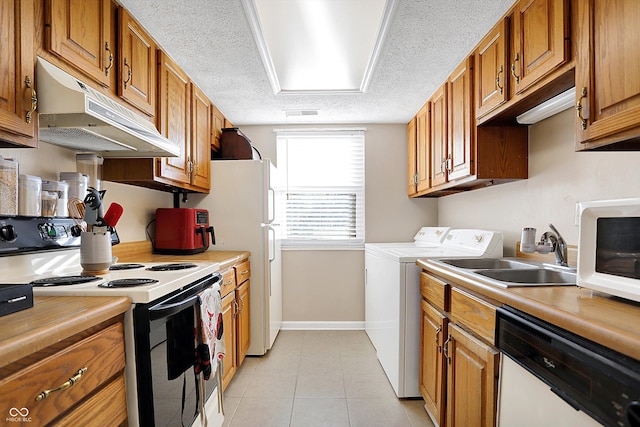 kitchen with sink, a textured ceiling, white appliances, light tile patterned flooring, and washer and dryer