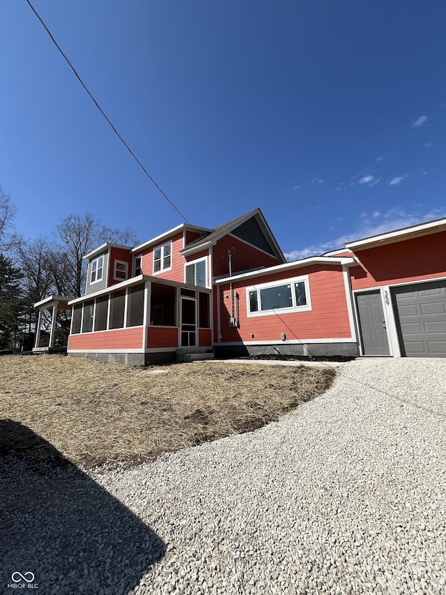 view of front of house featuring a garage and a sunroom