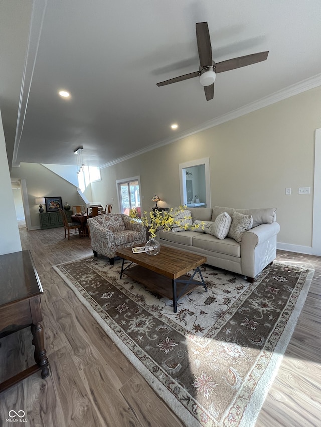 living room featuring hardwood / wood-style floors, ceiling fan, and ornamental molding