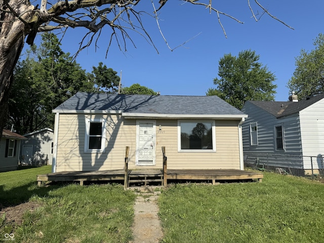 view of front facade featuring a front lawn and a wooden deck