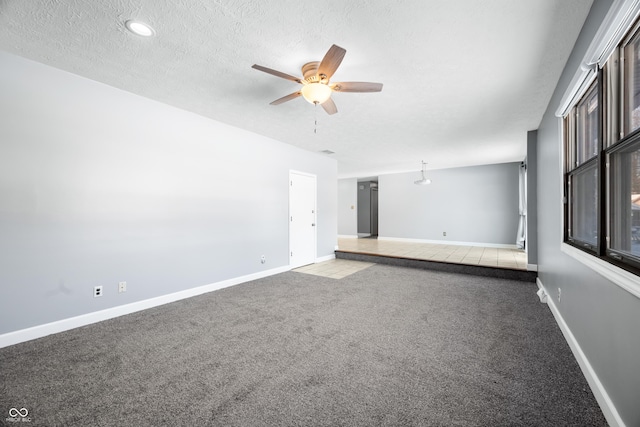 interior space with carpet flooring, a textured ceiling, and ceiling fan