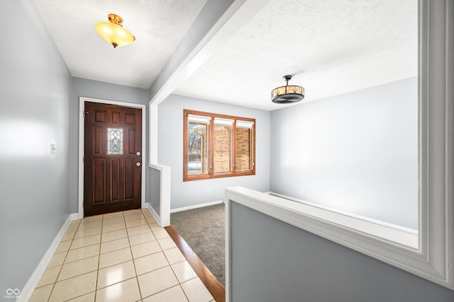 foyer with light tile patterned flooring and a textured ceiling