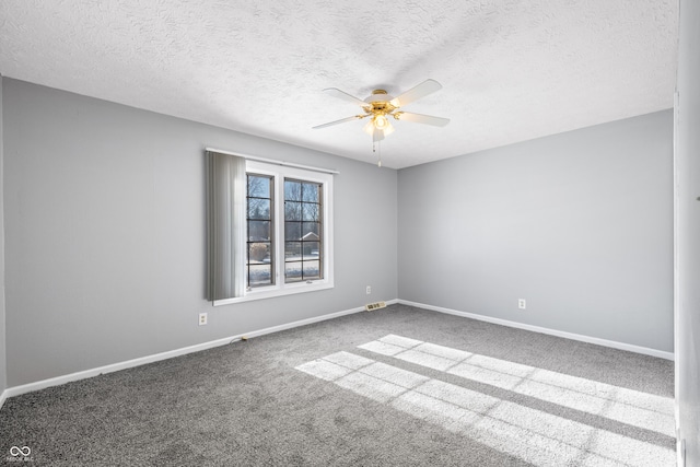 unfurnished room featuring carpet, ceiling fan, and a textured ceiling