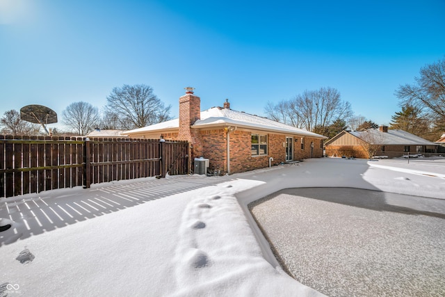 rear view of house with central AC unit