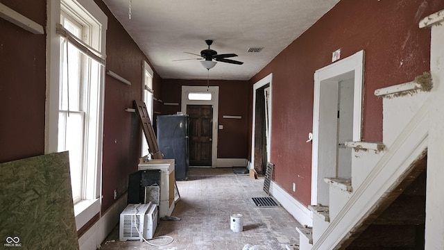 hall featuring a wealth of natural light