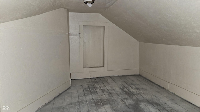 bonus room featuring lofted ceiling and hardwood / wood-style flooring