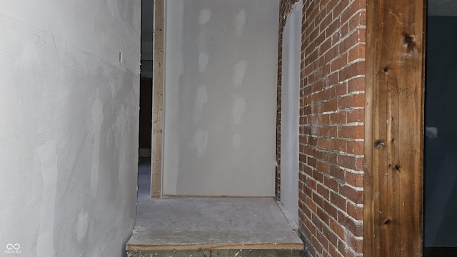 hallway with brick wall