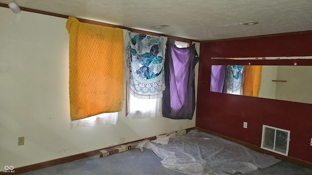 spare room featuring a textured ceiling