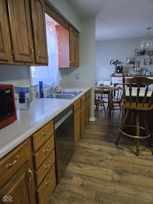 kitchen with sink, stainless steel dishwasher, and dark hardwood / wood-style floors