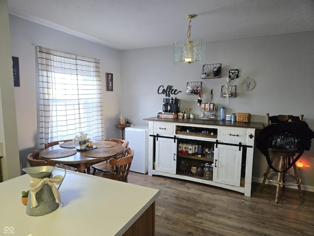 dining area featuring dark wood-type flooring