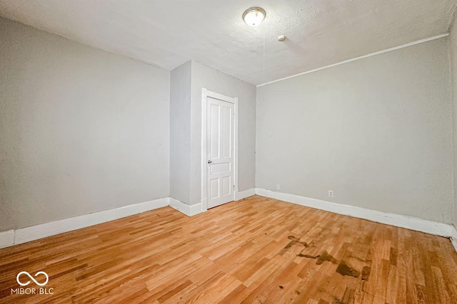 bonus room featuring a textured ceiling and hardwood / wood-style flooring