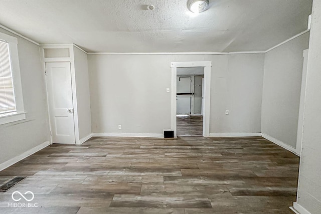 bonus room with a textured ceiling and hardwood / wood-style flooring