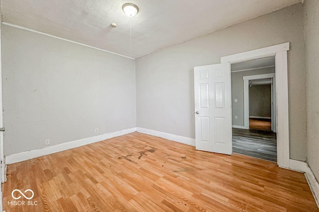 unfurnished room featuring hardwood / wood-style flooring and a textured ceiling