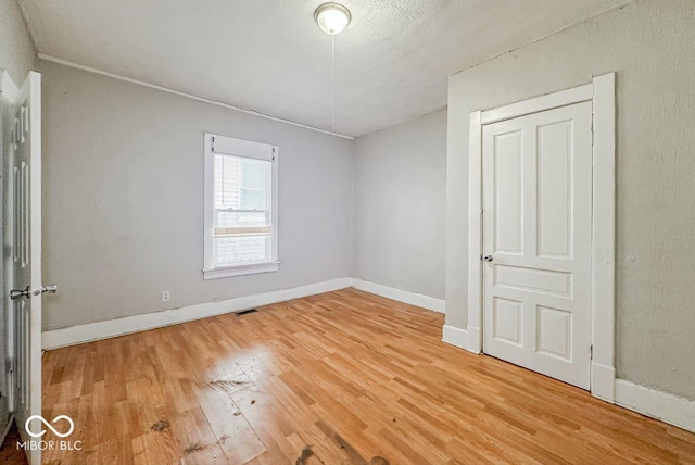 spare room with wood-type flooring