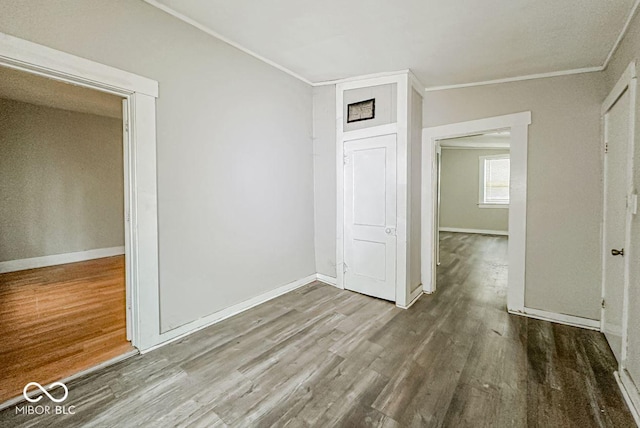 interior space with wood-type flooring and ornamental molding