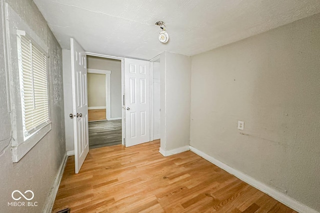 unfurnished bedroom with hardwood / wood-style flooring