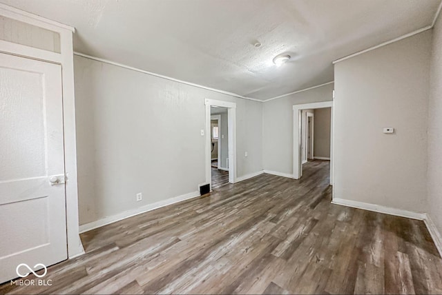 unfurnished room featuring hardwood / wood-style flooring, crown molding, and a textured ceiling