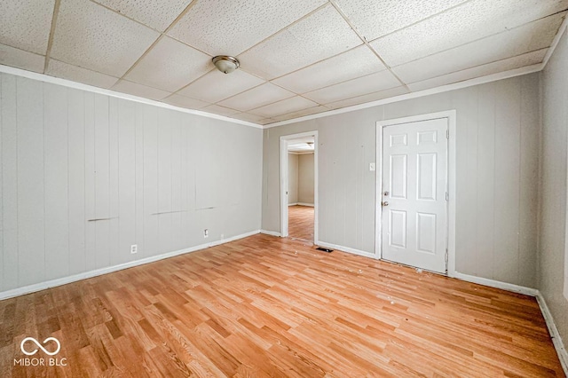 unfurnished room featuring a paneled ceiling and wood-type flooring