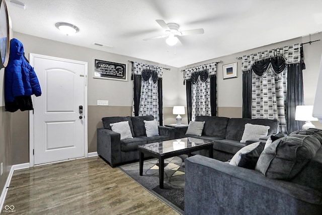 living room with a textured ceiling, hardwood / wood-style flooring, and ceiling fan