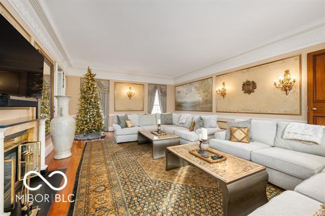 living room featuring crown molding and hardwood / wood-style flooring