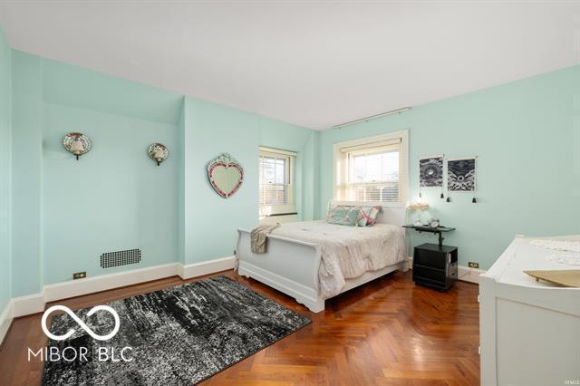 bedroom featuring parquet flooring