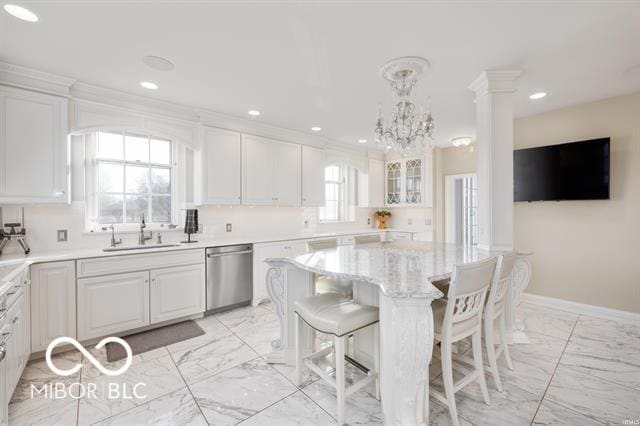 kitchen featuring a center island, sink, stainless steel dishwasher, a notable chandelier, and white cabinets