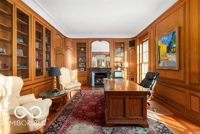 home office with built in features and ornamental molding