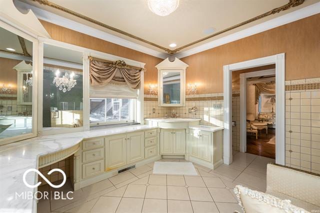 bathroom featuring tile patterned floors, vanity, backsplash, and crown molding