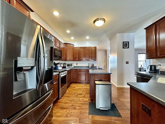 kitchen featuring light wood-type flooring and black appliances