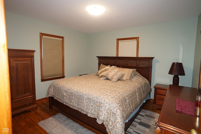 bedroom with dark hardwood / wood-style floors