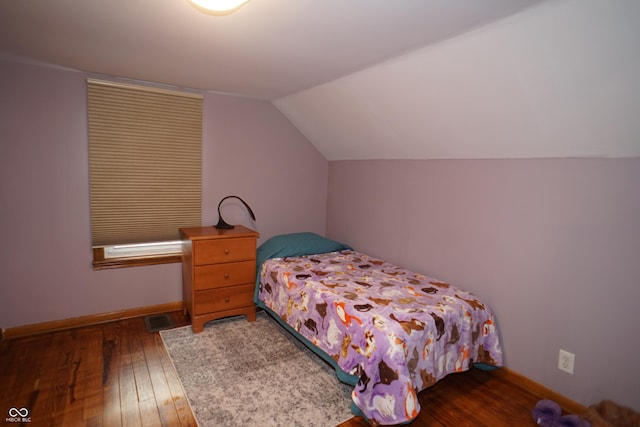 bedroom featuring vaulted ceiling and hardwood / wood-style flooring