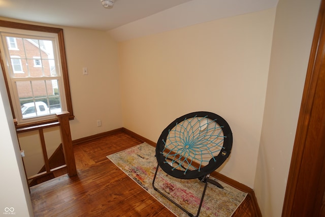 living area with dark hardwood / wood-style flooring and vaulted ceiling