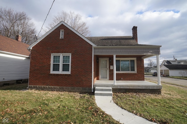 bungalow-style house with covered porch and a front lawn