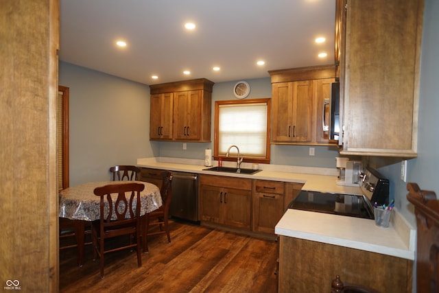 kitchen featuring dishwasher, dark hardwood / wood-style flooring, range with electric stovetop, and sink