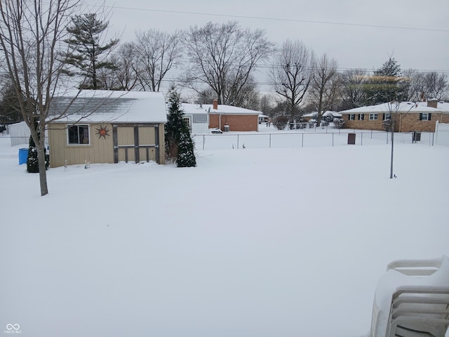 snowy yard featuring an outdoor structure