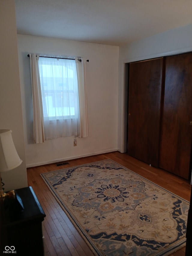 unfurnished bedroom with hardwood / wood-style floors and a closet