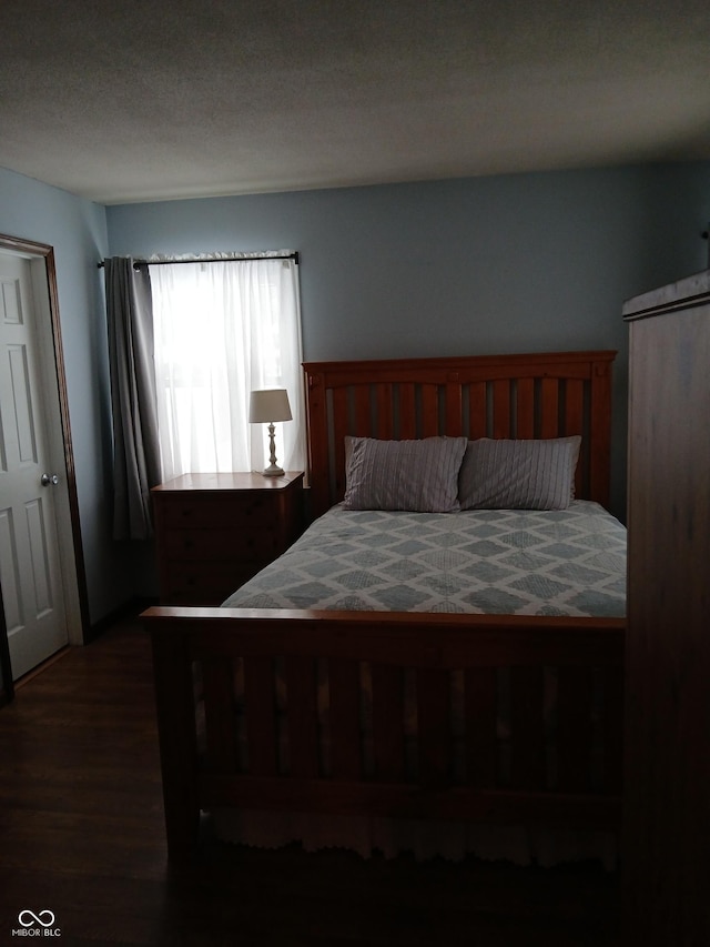 bedroom featuring dark hardwood / wood-style floors