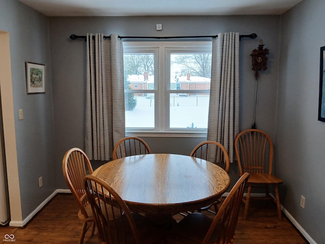 dining area with plenty of natural light and dark hardwood / wood-style floors